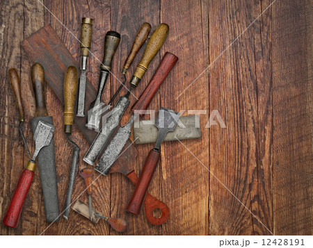 vintage chisels and stones collage over old wooden bench 12428191