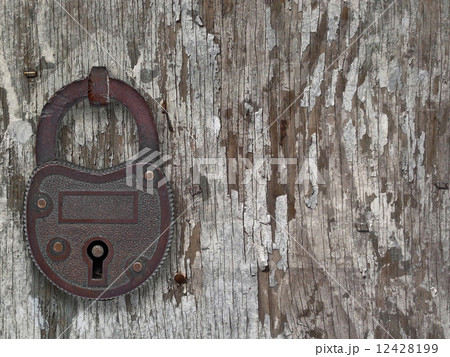 vintage padlock on a old door vintage padlock on a old door 12428199