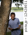 Young Asian man with with a book  12428651