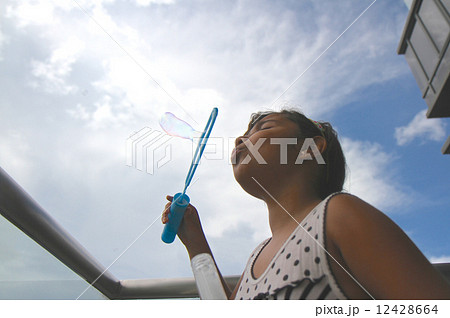 Girl Blowing Bubbles 12428664