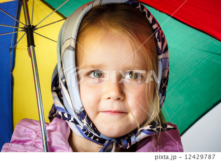 Cute little girl with colorful umbrella 12429787