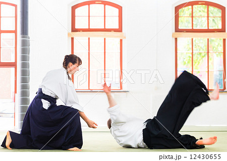 Aikido teacher and student training throwing and falling 12430655