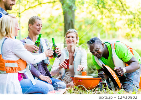 Friends barbecue in forest drinking beer 12430802