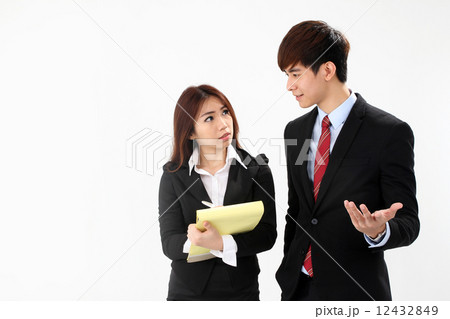 Asian female executive taking notes from boss or customer Asian female executive taking notes from boss or customer 12432849