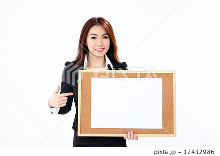 Female business executive holding notice board Female business executive holding notice board 12432986