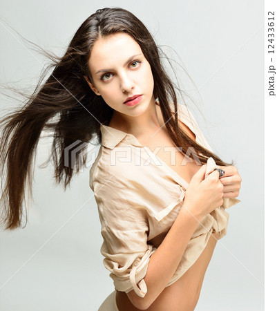 Beautiful  naked woman with long hair in light shirt 12433612