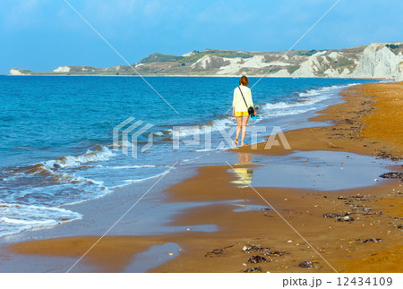 Woman and Xi Beach morning view (Greece, Kefalonia). 12434109