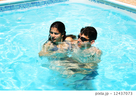 Couple in swimming pool Couple in swimming pool 12437073