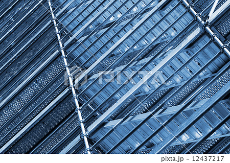 Modern metal scaffolding on wall, blue toned 12437217