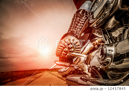 Biker girl riding on a motorcycle 12437845