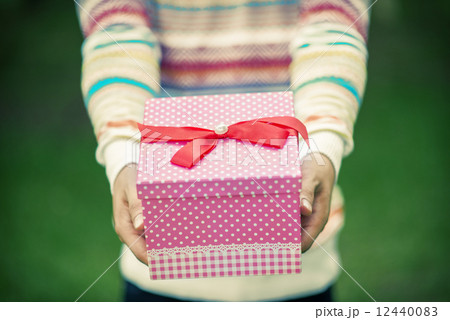 Male hands holding and giving gift 12440083