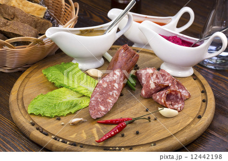 sausages on a wooden plate with vegetables in a restaurant 12442198