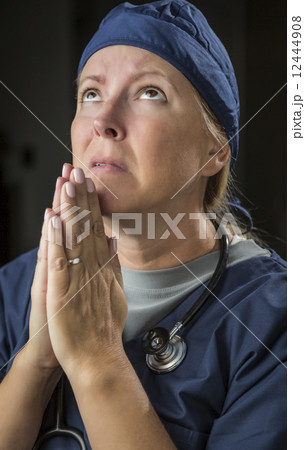 Pleading in Prayer Female Doctor or Nurse 12444908