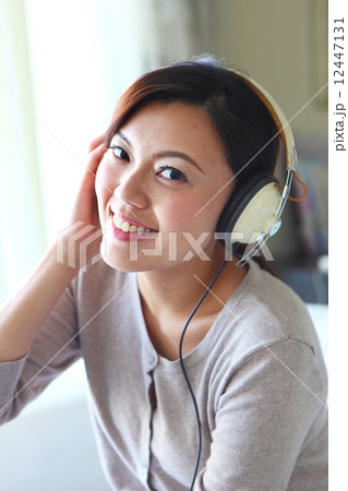 Young Women, Home, Resort, Hotel, apartment, Condo, Lifestyle, listening, smiling, relax, headphone 12447131