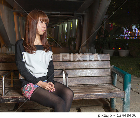 Sad Asian Woman on a Park Bench Sad Asian Woman on a Park Bench 12448406
