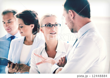 man and woman having discussion in office 12448884