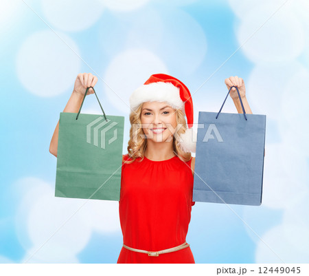 woman in santa helper hat with shopping bags woman in santa helper hat with shopping bags 12449045