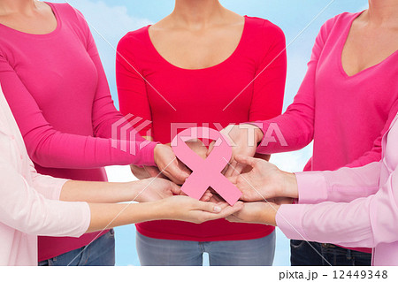 close up of women with cancer awareness ribbons close up of women with cancer awareness ribbons 12449348