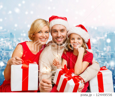 happy family in santa helper hats with gift boxes happy family in santa helper hats with gift boxes 12449556