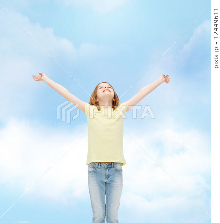 smiling teenage girl with raised hands 12449611