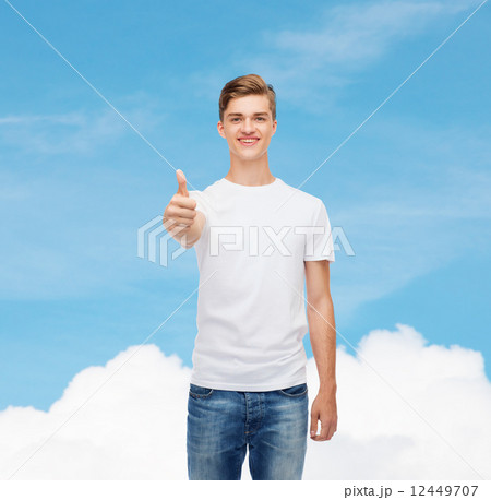 smiling man in white t-shirt showing thumbs up smiling man in white t-shirt showing thumbs up 12449707