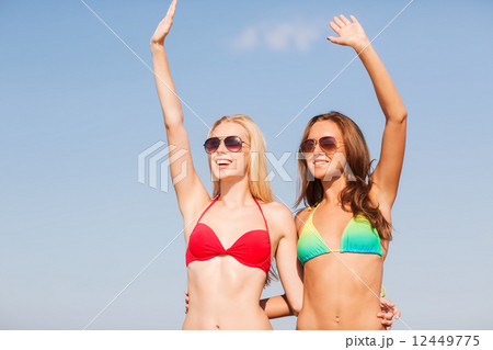 two smiling young women on beach 12449775