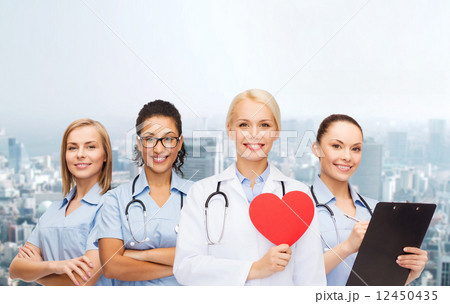 smiling female doctor and nurses with red heart 12450435
