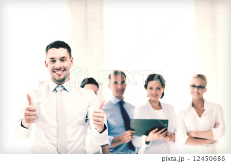 businessman in office showign thumbs up businessman in office showign thumbs up 12450686