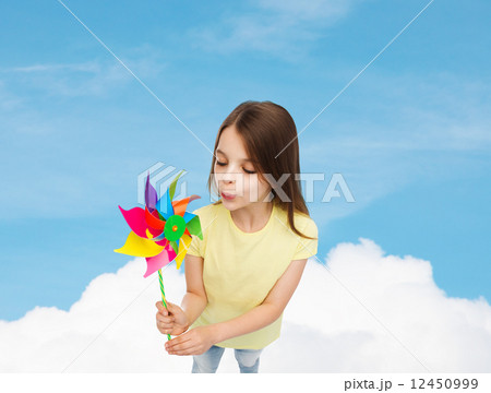 smiling child with colorful windmill toy smiling child with colorful windmill toy 12450999