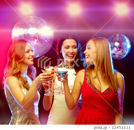 three smiling women with cocktails and disco ball 12451111