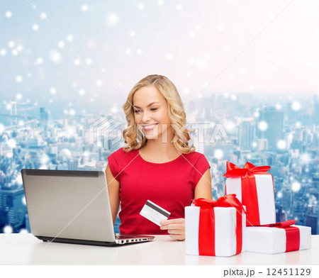 smiling woman with credit card and laptop 12451129