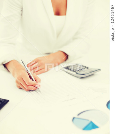 businesswoman working with calculator in office 12451467