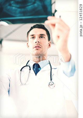 male doctor or dentist looking at x-ray 12451629