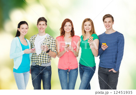 smiling students with smartphones 12451935