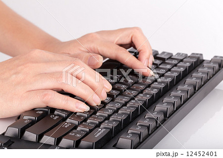 Female hands typing on computer keyboard 12452401