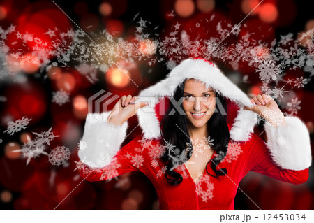 Composite image of woman wearing sexy christmas clothes 12453034