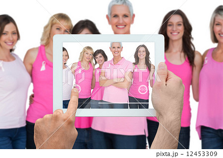 Composite image of hand holding tablet pc Composite image of hand holding tablet pc 12453309