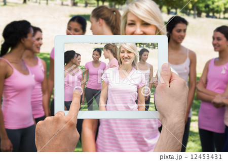 Composite image of hand holding tablet pc Composite image of hand holding tablet pc 12453431