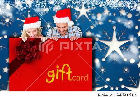 Composite image of young festive couple Composite image of young festive couple 12453437