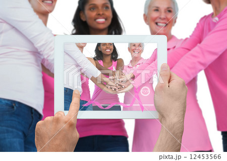 Composite image of hand holding tablet pc 12453566