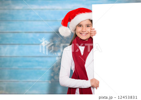 Composite image of festive little girl showing card Composite image of festive little girl showing card 12453831