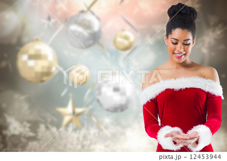 Composite image of pretty santa girl presenting with hands Composite image of pretty santa girl presenting with hands 12453944