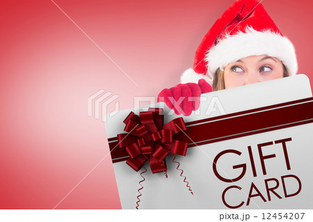 Composite image of festive blonde holding a poster 12454207