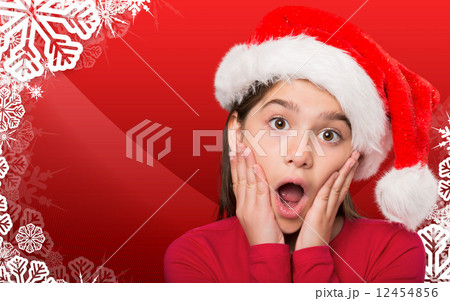 Composite image of festive little girl looking surprised 12454856