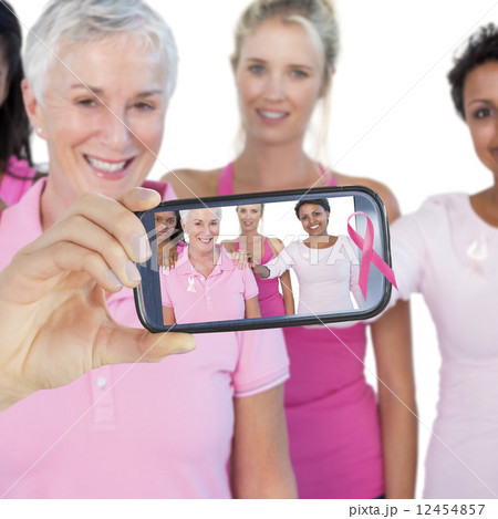 Composite image of hand holding smartphone showing 12454857