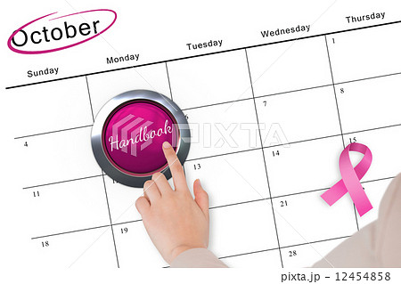 Hand pushing pink button for breast cancer awareness 12454858
