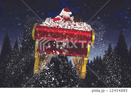 Composite image of santa flying his sleigh 12454885