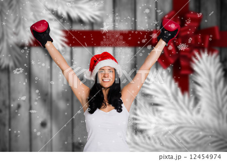 Composite image of woman wearing red boxing gloves 12454974