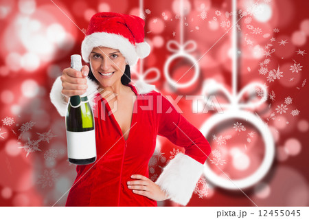 Composite image of woman holding a champagne bottle Composite image of woman holding a champagne bottle 12455045