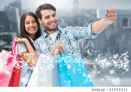 Composite image of happy couple taking a selfie 12455311